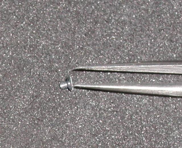 Picking up flash socket screws with tweezers